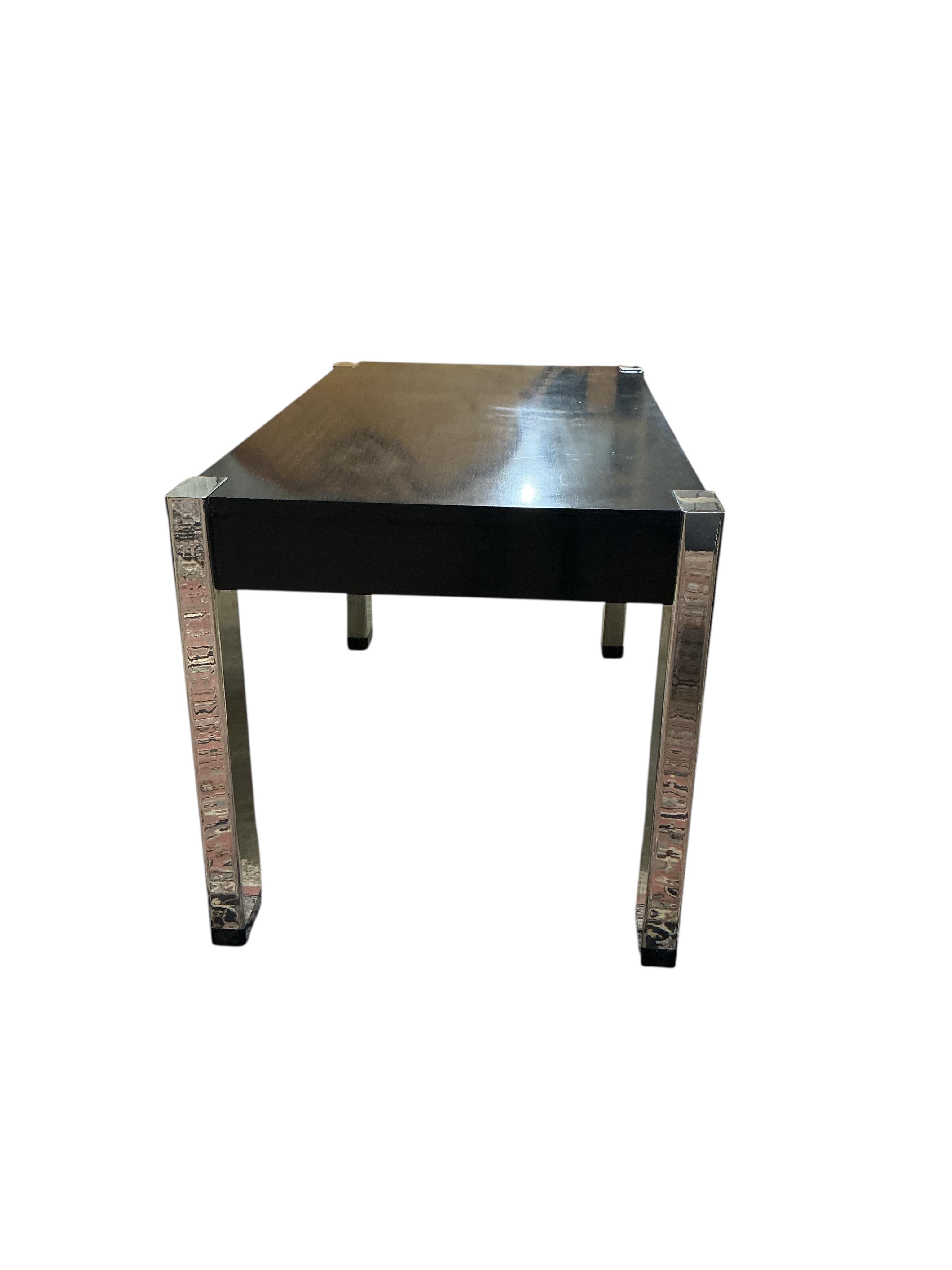 A Contemporary ebonised and chrome desk, retailed by Harrods, width 139cm, depth 78cm, height 78cm